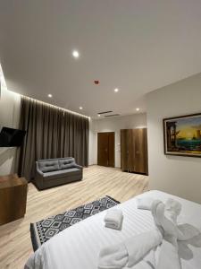 a large bedroom with a bed and a couch at Hotel Kroi near castle entrance castle and town view in Krujë