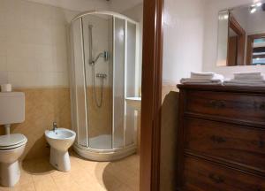 a bathroom with a shower and a toilet and a sink at La casa degli zii in Ferrara