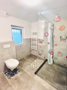 a bathroom with a toilet and a shower at Blue Sun in Ljubljana +17 photos