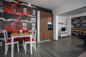 a kitchen and living room with a table and chairs at Sabrina Studios in Faliraki