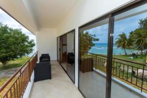 a balcony with a view of the ocean at Beach Cottages in Bel Ombre