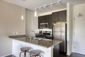 a kitchen with a counter top and a refrigerator at Evanston 1BR w Pool Gym nr Nwestern CHI-702 in Evanston