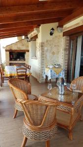 a patio with a table and chairs and a fireplace at Villa paradiso in Stintino