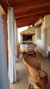 a patio with a table and chairs and a fireplace at Villa paradiso in Stintino