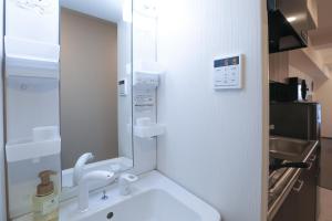 a bathroom with a sink and a mirror at LEOPARD Shinsaibashi in Osaka +29 photos