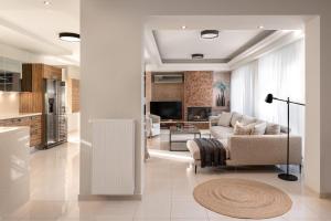a living room with a couch and a table at Emmelia Villa in Ialyssos +28 photos