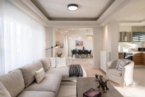 a living room with a couch and a table at Emmelia Villa in Ialyssos