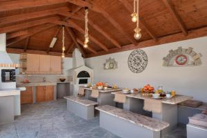 a kitchen with a table and benches in a room at Emmelia Villa in Ialyssos