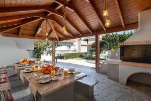 an outdoor patio with a table with fruit on it at Emmelia Villa in Ialyssos