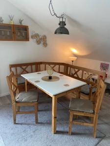 a dining room table with two chairs and a table with a lamp at Penthouse N74 Linz 120 QM KIDS WELCOME! in Linz