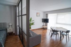 a living room with a table and a couch at Ornis Apartments Poble in Sant Carles de la Ràpita