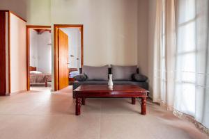 a living room with a couch and a coffee table at Porto Kalamitsi Stone-built Bungalows in Kardamili
