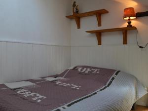 a bedroom with a bed with a blanket on it at Maison Fleury-Saint-Pierre-la-Mer, 1 pièce, 4 personnes - FR-1-229D-239 in Saint Pierre La Mer