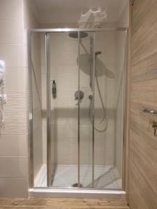 a shower with a glass door in a bathroom at San Giuseppe Casa per Ferie in Quercianella