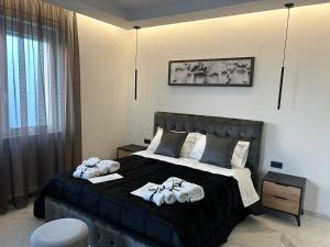 a bedroom with a large bed with towels on it at DIADEMA Luxury Suite in Nardò