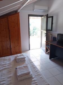 a room with a bed with towels on the floor at Christos center rooms in Raches