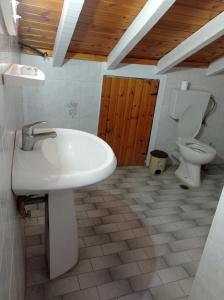 a bathroom with a sink and a toilet at Christos center rooms in Raches