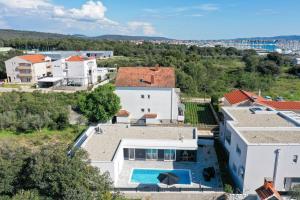 an aerial view of a white house with a swimming pool at La Reina House - Private Heated Pool in Bibinje