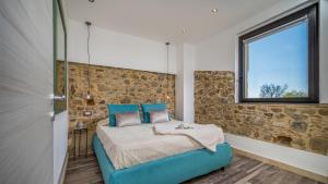 a bedroom with a blue bed and a window at VILLA GALLUS 6, Emma Villas in Taormina +18 photos
