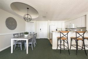 a kitchen with a table and chairs and a dining room at Unit 2432 Ocean Walk - 2 Bedroom Ocean View in Daytona Beach