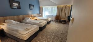 Łóżko lub łóżka w pokoju w obiekcie Hotel Wojciech