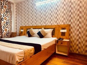 a bedroom with a large bed with a wooden headboard at WooibHotels The Solitaire in Manāli