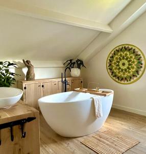 a bathroom with a large white tub in a room at B&B Logement 't Slikje in Groede