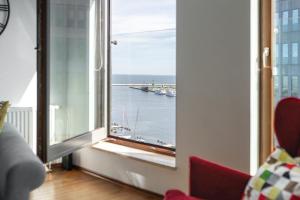 a room with a window with a view of a harbor at Glob Apartament Sea Towers Gdynia in Gdynia