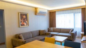 a living room with a couch and a table at Bursa Suites Apart Otel in Bursa