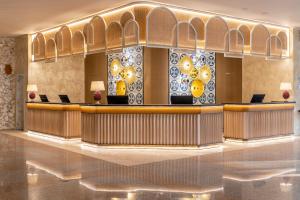 a lobby with a bar in a building at Delta Hotels by Marriott Giardini Naxos in Giardini Naxos