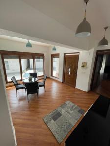 a living room with a table and chairs at Ilija Apartments in Gevgelija +1 photo