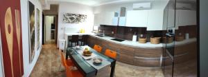 a kitchen with orange chairs and a counter top at Lemnos Luxury Apartment in Mirina