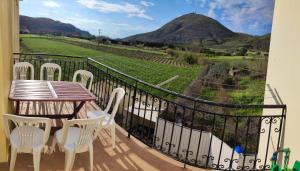 a balcony with a table and chairs and a view at Lemnos Luxury Apartment in Mirina