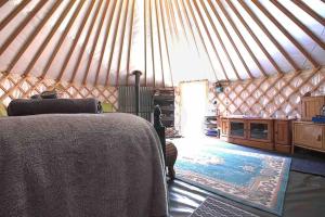 a bedroom with a bed in a yurt at Magical Forest yurt in Sturry