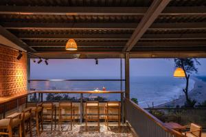 a bar with chairs and a view of the ocean at Zostel Gokarna in Gokarna