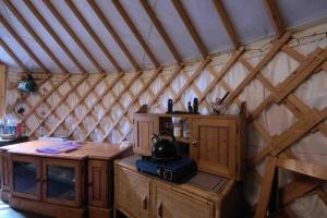 a room with a yurt with a tea kettle on a table at Magical Forest yurt in Sturry