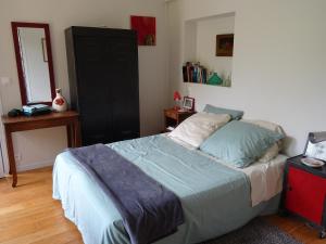 una camera con letto e armadio nero di Chambre d'hôtes sur jardin acces PMR a Caen