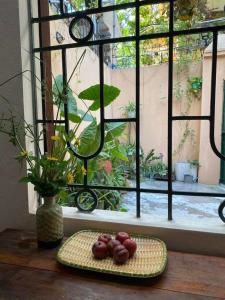 a plate of donuts on a table in front of a window at T30 Hanoi Homestay, near Lotte Tay Ho, 25minutes to the airport in Hanoi