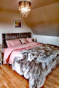 a bedroom with a large bed with a furry rug at Mourne Magic House-Riverside luxury in Newcastle in Newcastle