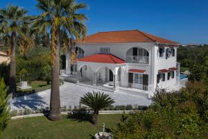 an aerial view of a house with palm trees at Aigli Villa in Zakynthos Town