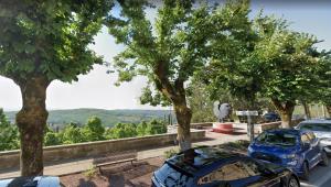 two cars parked in a parking lot with trees at Casa Furielli in Radda in Chianti