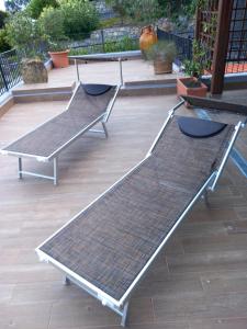 a group of benches sitting on a patio at Casa Maggiali in Portovenere