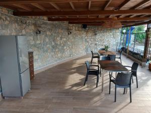 a dining room with tables and chairs and a stone wall at Casa Maggiali in Portovenere