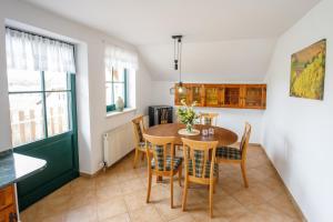 a kitchen and dining room with a table and chairs at Vinařský apartmán Špalek in Nový Šaldorf