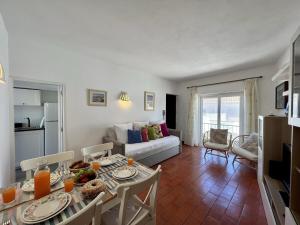 a kitchen and living room with a table and chairs at Lagos Ocean Breeze by Homing in Lagos