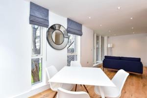 a white dining room with a white table and chairs at Luxury 2 Bedroom 2 bathroom Apartment -Borough Market/ London Bridge in London