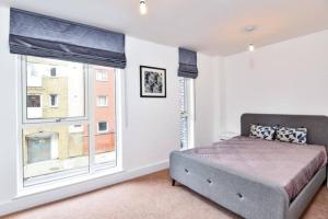 a bedroom with a bed and a large window at Luxury 2 Bedroom 2 bathroom Apartment -Borough Market/ London Bridge in London