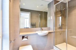 a bathroom with a sink and a glass shower at Luxury 2 Bedroom 2 bathroom Apartment -Borough Market/ London Bridge in London