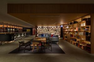 a library with a couch and a table and chairs at Shinagawa Prince Hotel in Tokyo