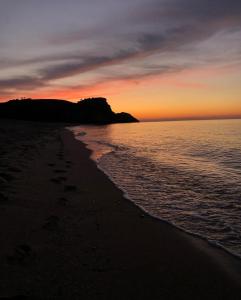 a sunset on a beach with footprints in the sand at SB KAMP ŞİLE in Şile